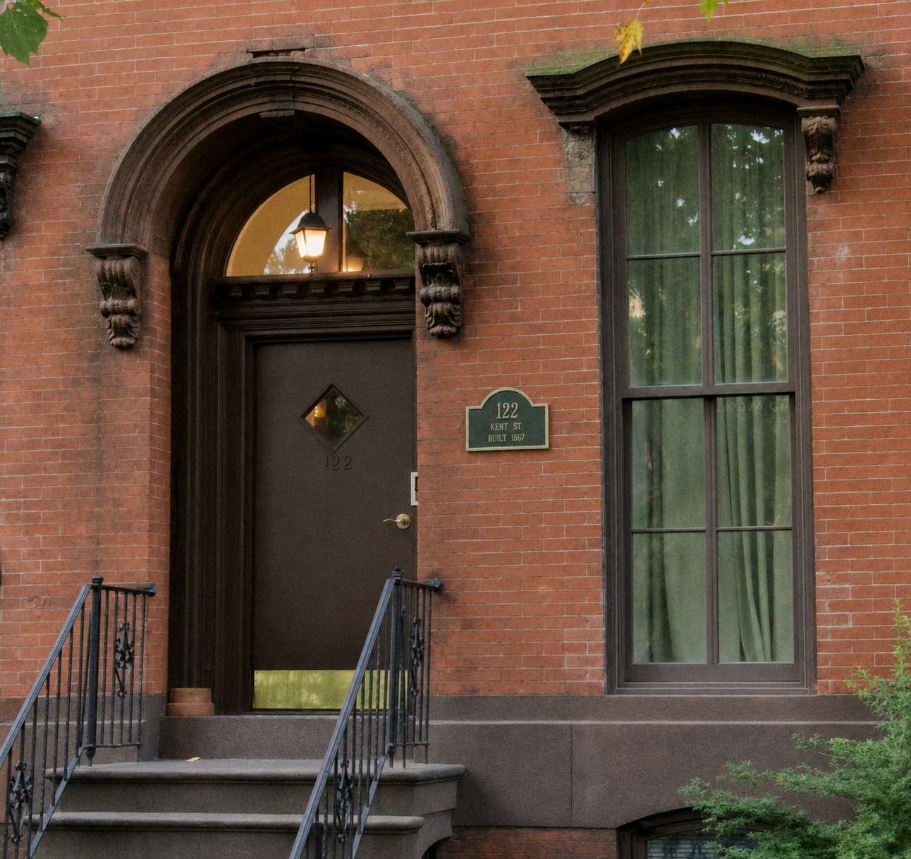Arched entrance and brick façade at 122 Kent Street in Greenpoint, Brooklyn.
